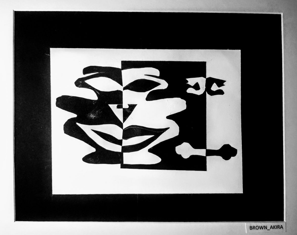 Face of cut paper with black paper on one side and white on the other.