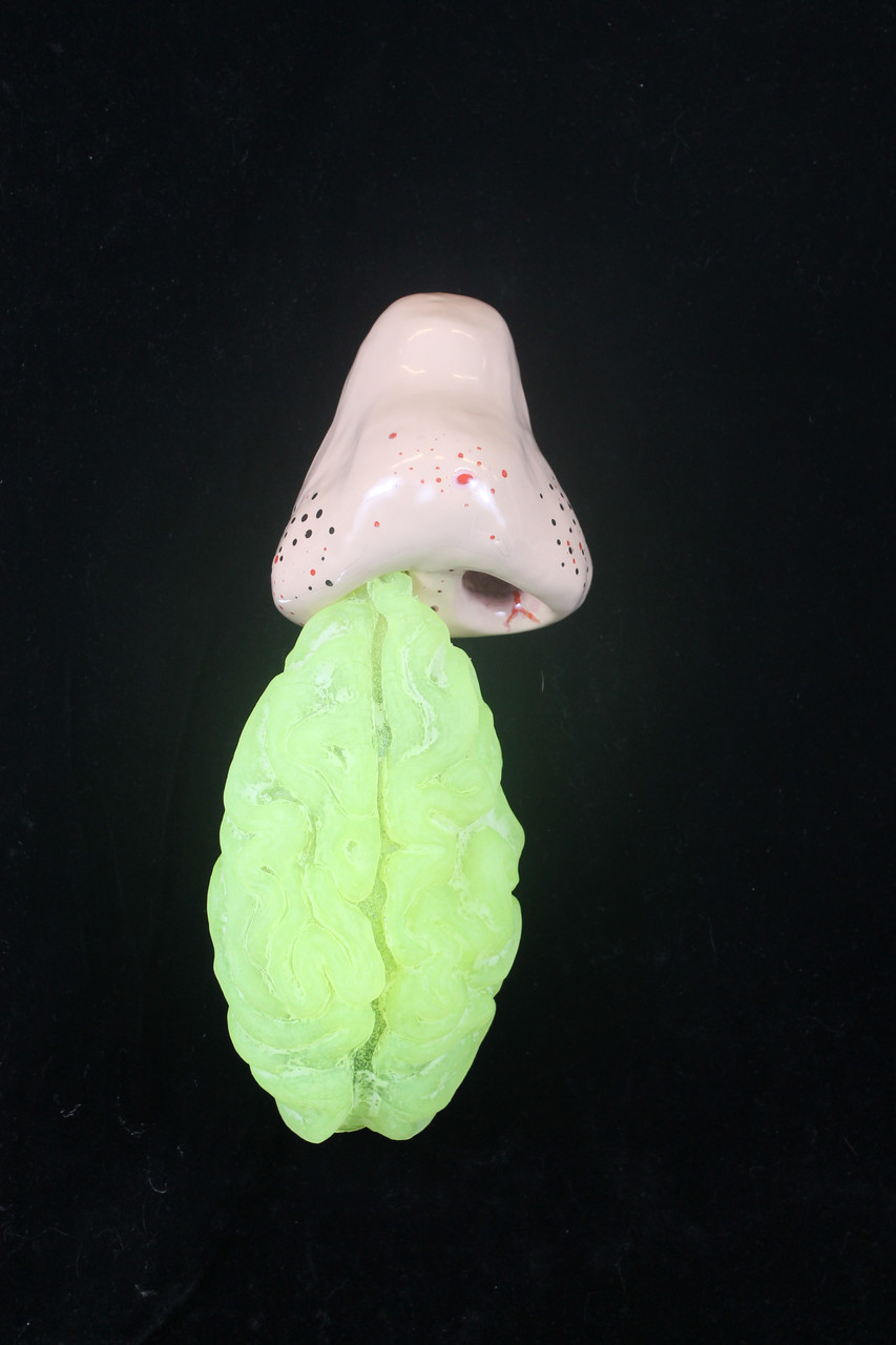 Ceramic sculpture of nose with green snot coming out of the right nostril