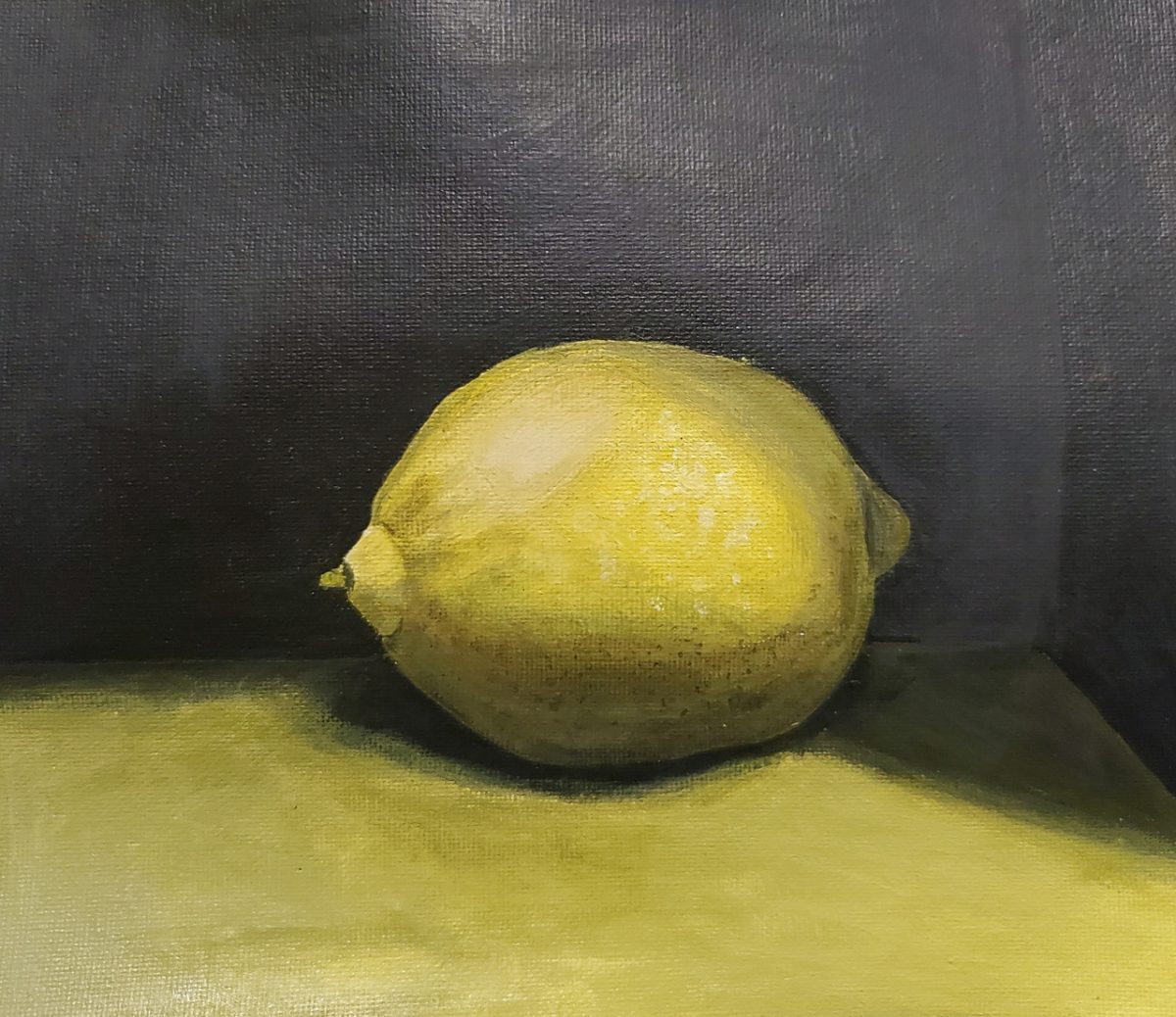 Painting of a lemon on a light colored table and black background