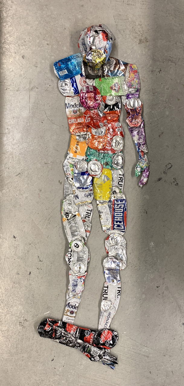 Sculpture of person with aluminum cans