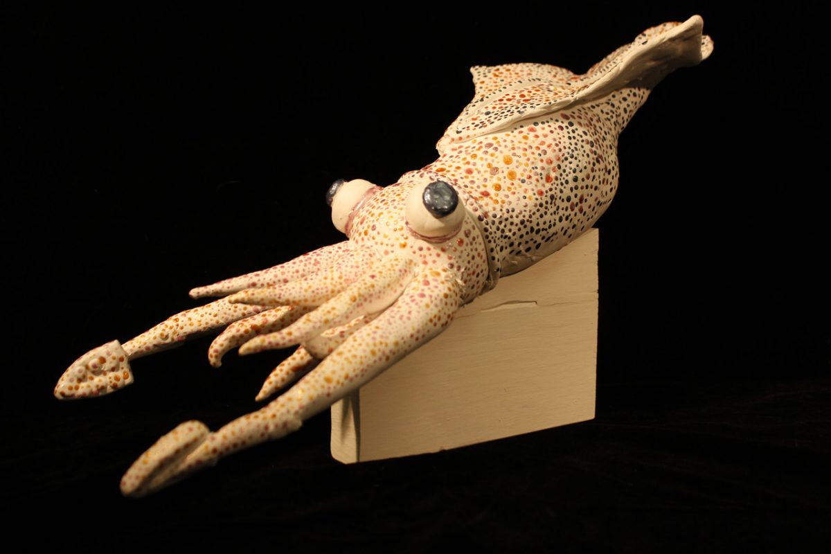 Sculpture of white squid with decorative pattern on body