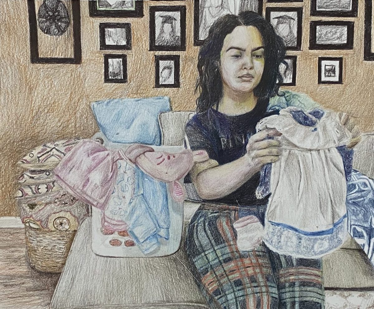 Illustration of the artist folding her baby clothes.