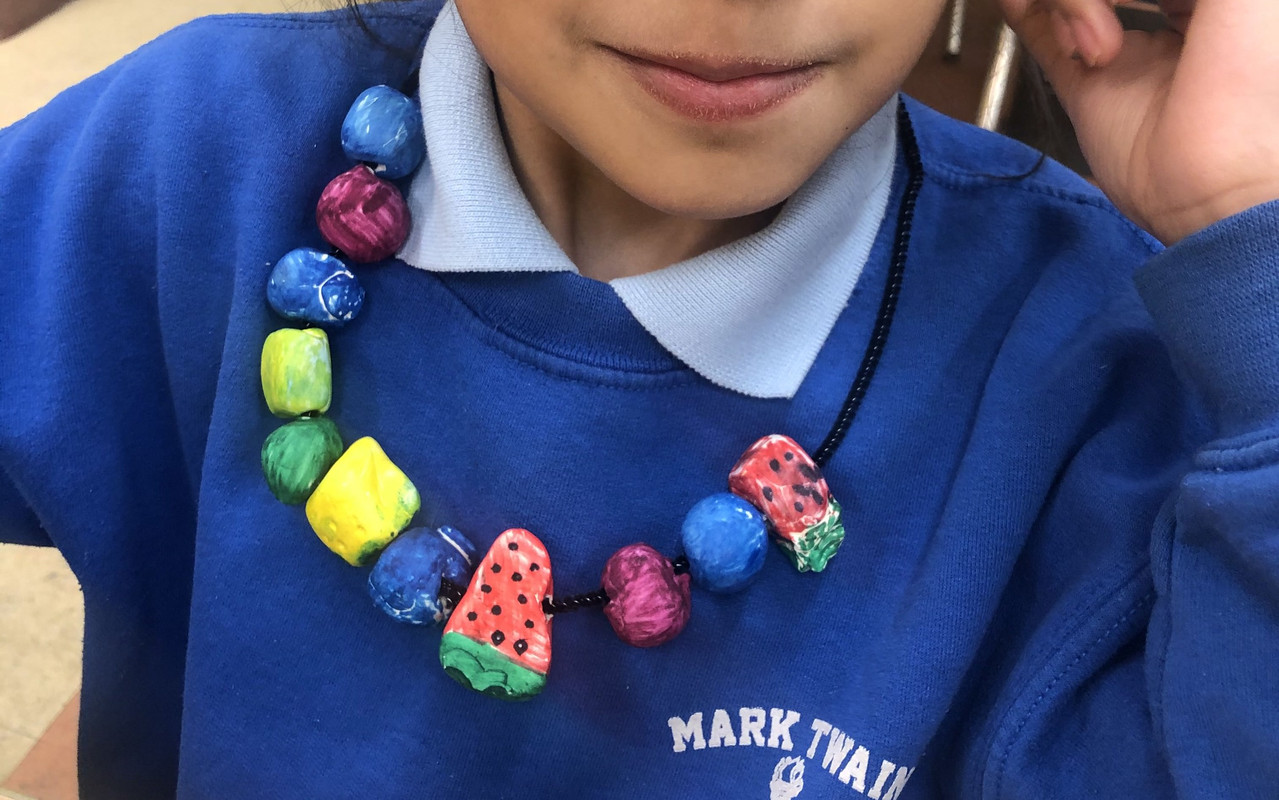 A necklace with different fruits like watermelon and blueberries