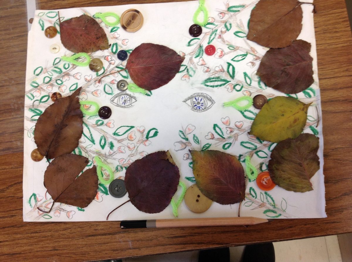 Illustration of eyes and leaves with actual leaves around the outer edge