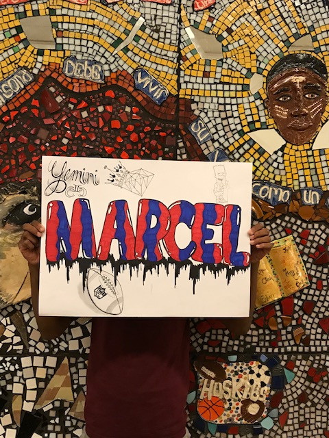 The design of red and blue letters that spell out the name "Marcel"