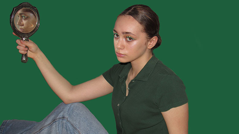Photo of girl holding a mirror