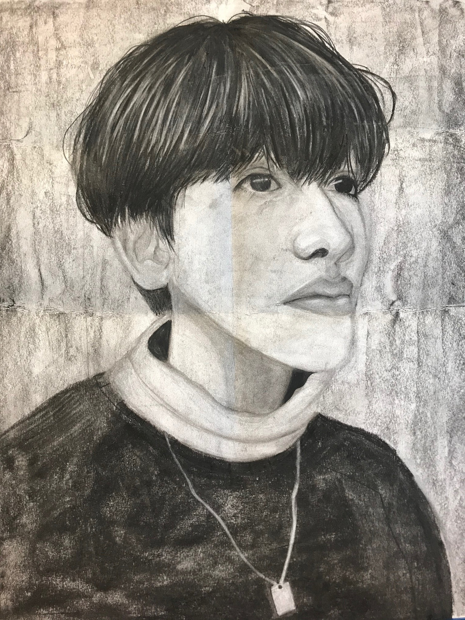 Black and white drawing of person with dark hair wearing black and white turtleneck and necklace.