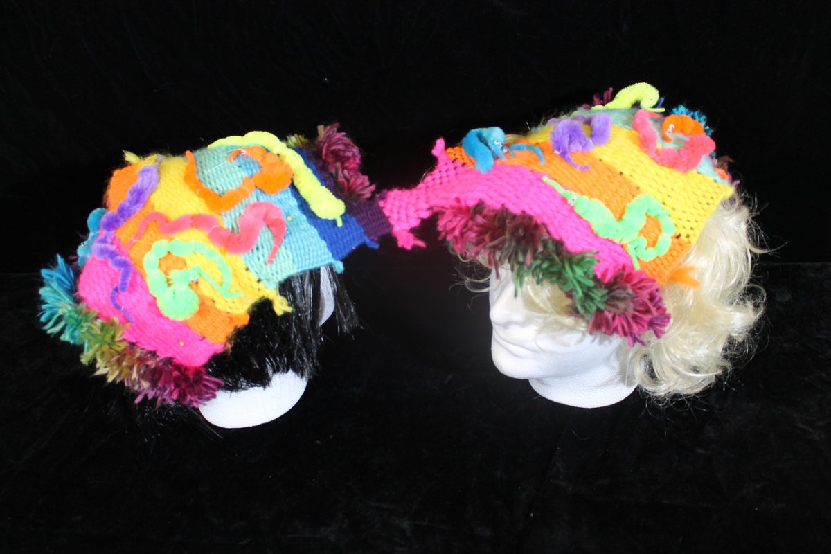 White foam heads with colorful yarn on their heads