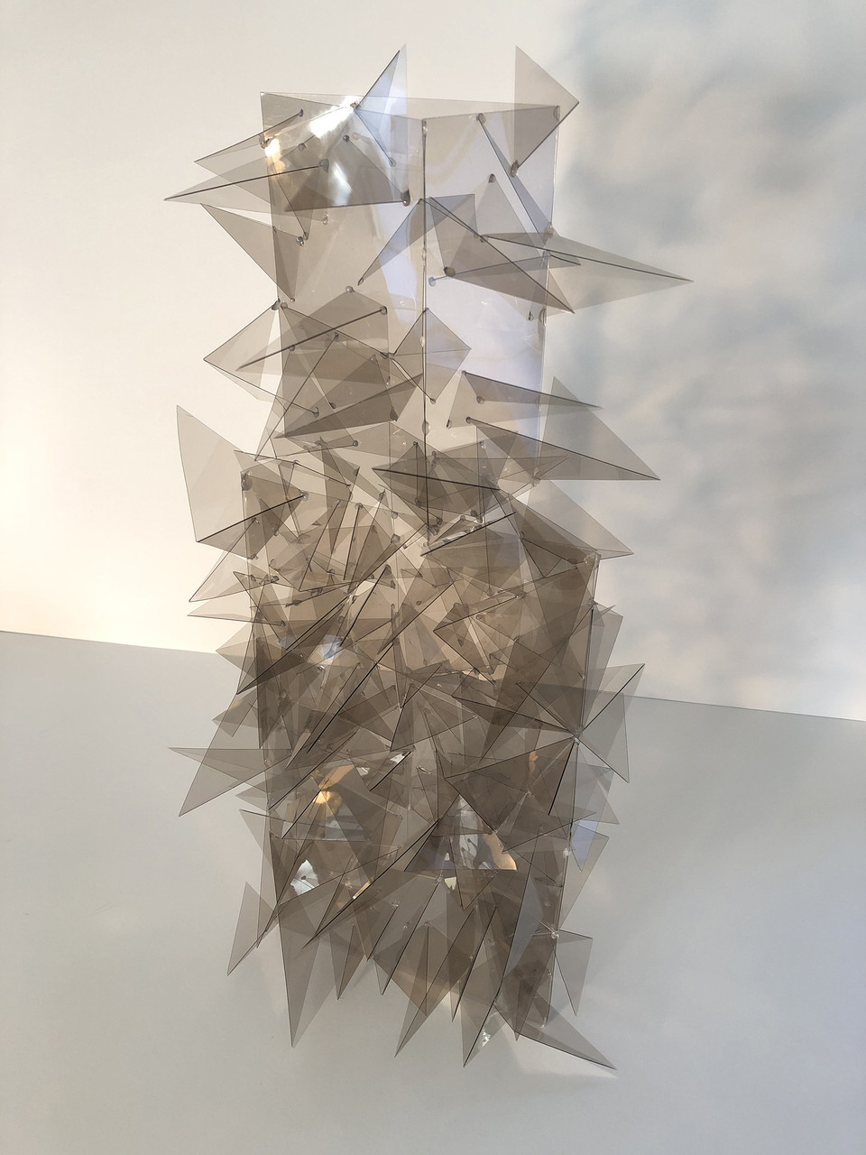 Clear triangular cut pieces attached to a clear rectangular prism