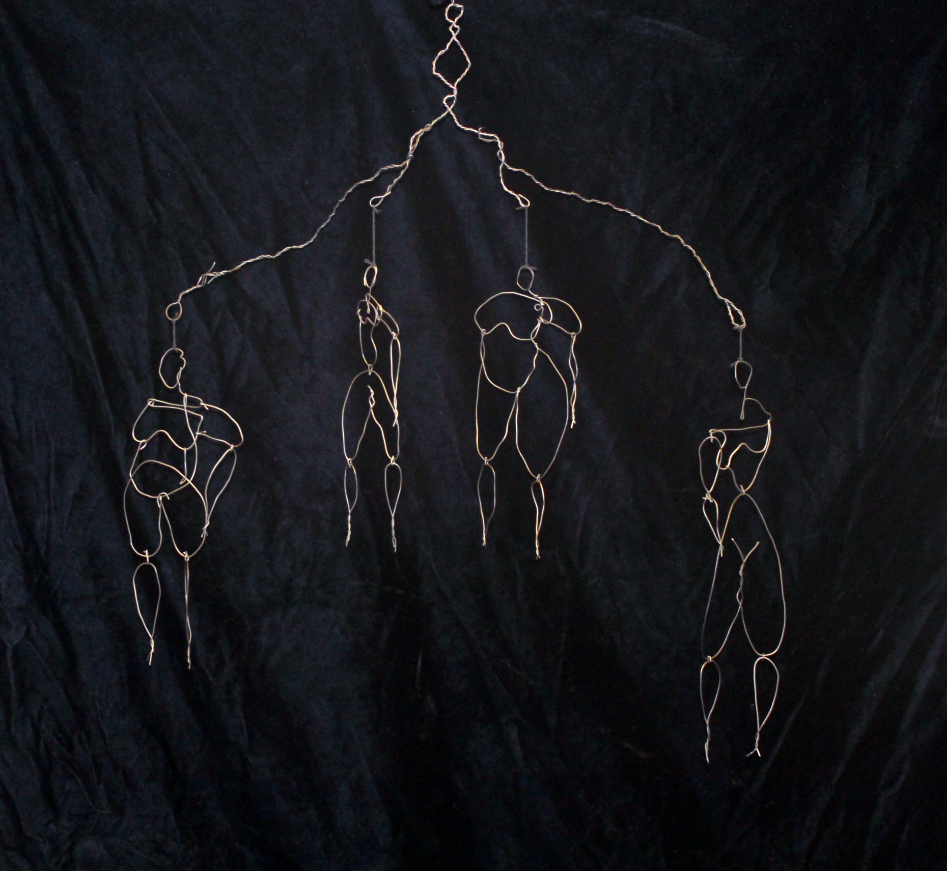Wire mobile with torsos of different body types.