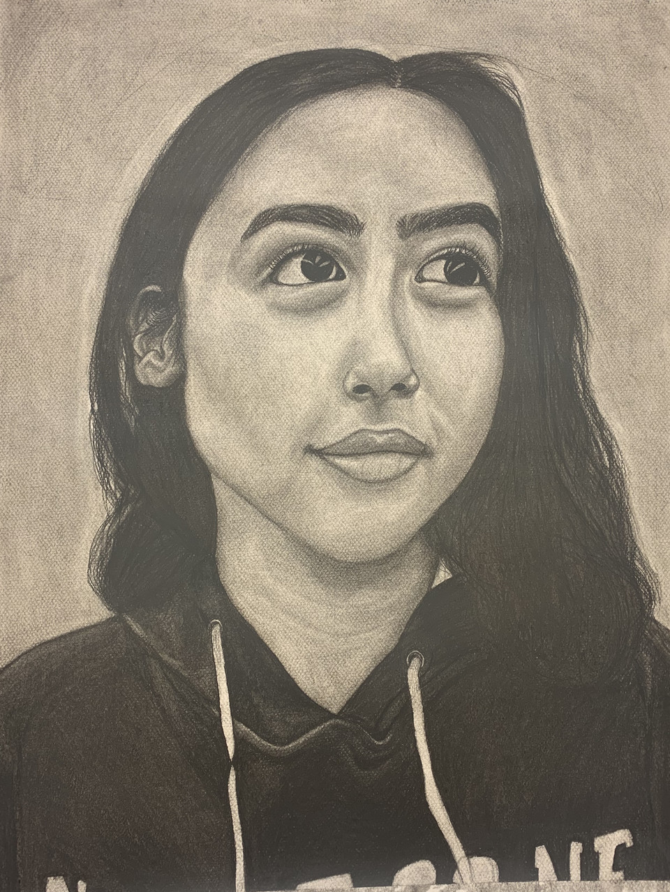 Black and white drawing of person with long dark hair wearing a black hoodie.
