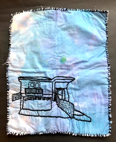 Embroidery of a house on white fabric