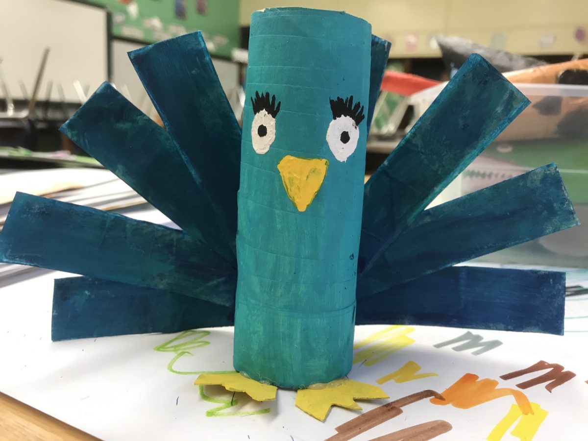 Paper sculpture of teal peacock