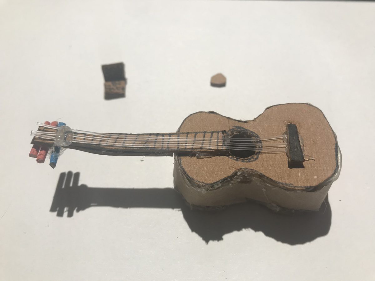 A miniature sculpture of a guitar