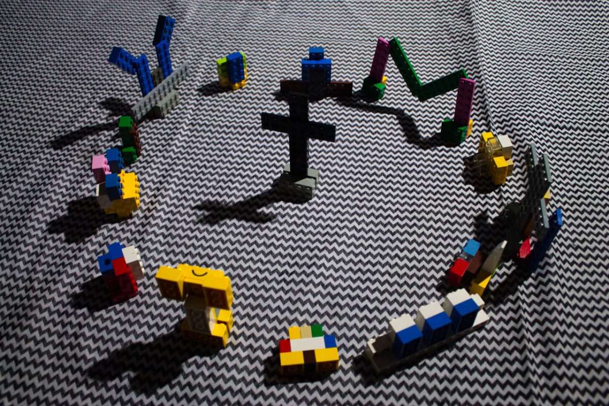 Photo of circle of lego figures around toy cross