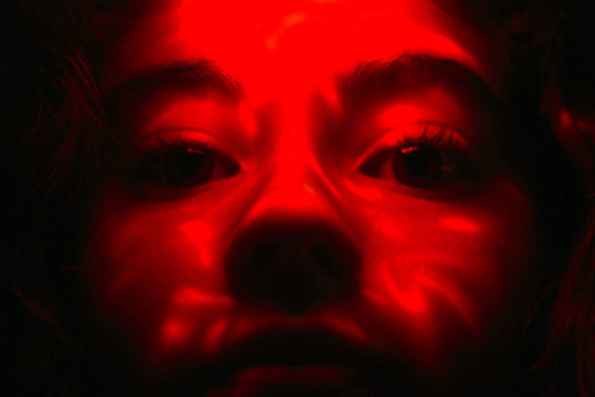 Photo of face bathed in red light