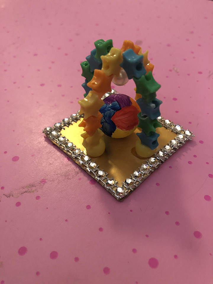 Arch made of colorful pieces on a gold platform