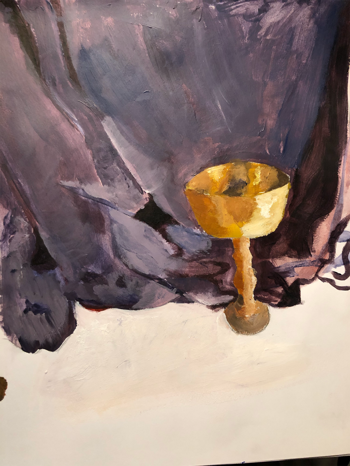 gold chalice against purple sheet