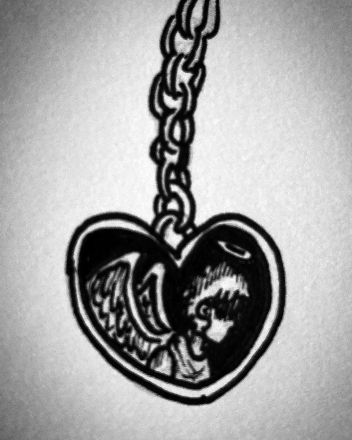 heart charm with an angel on it