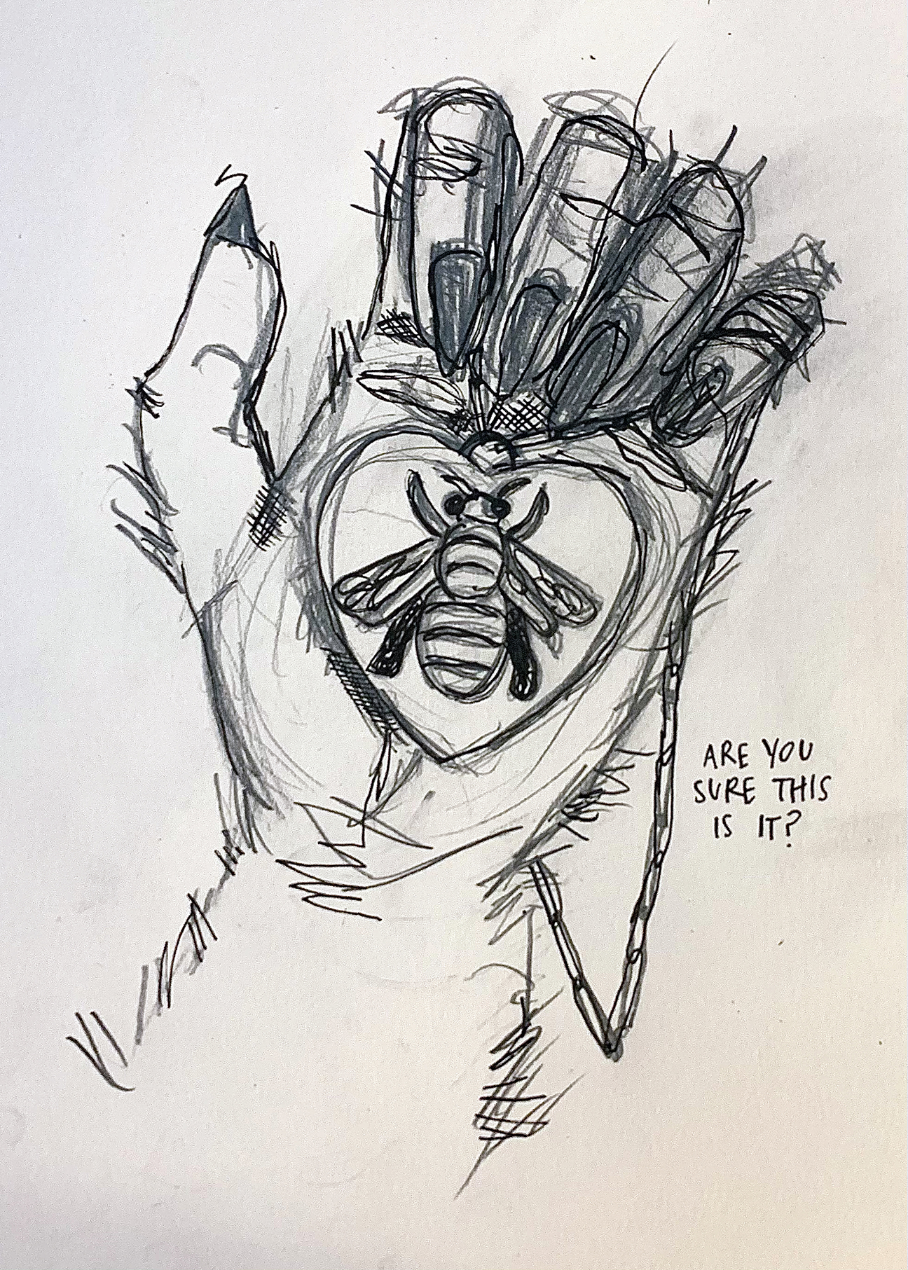 hand with a charm with a bee on a heart in the palm