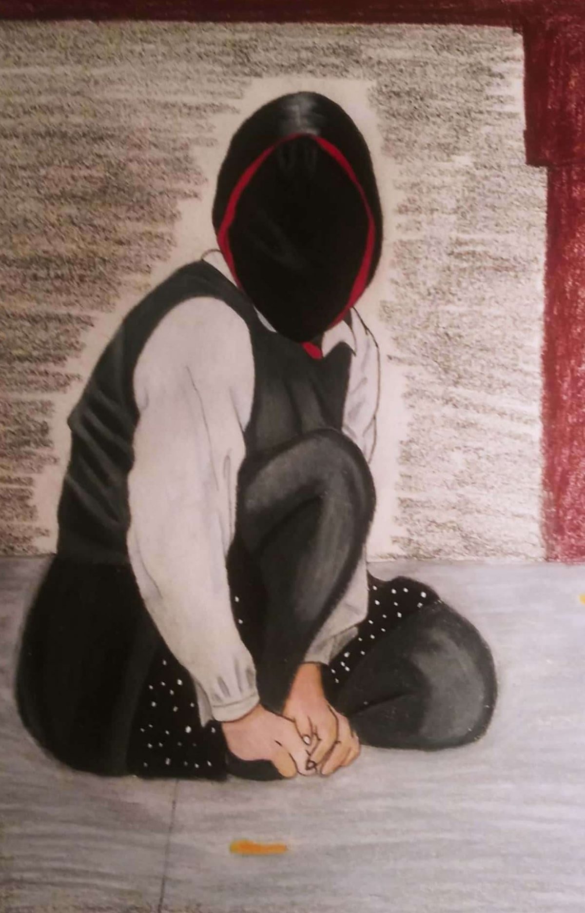 person crouching on the ground and their face is a black oval.