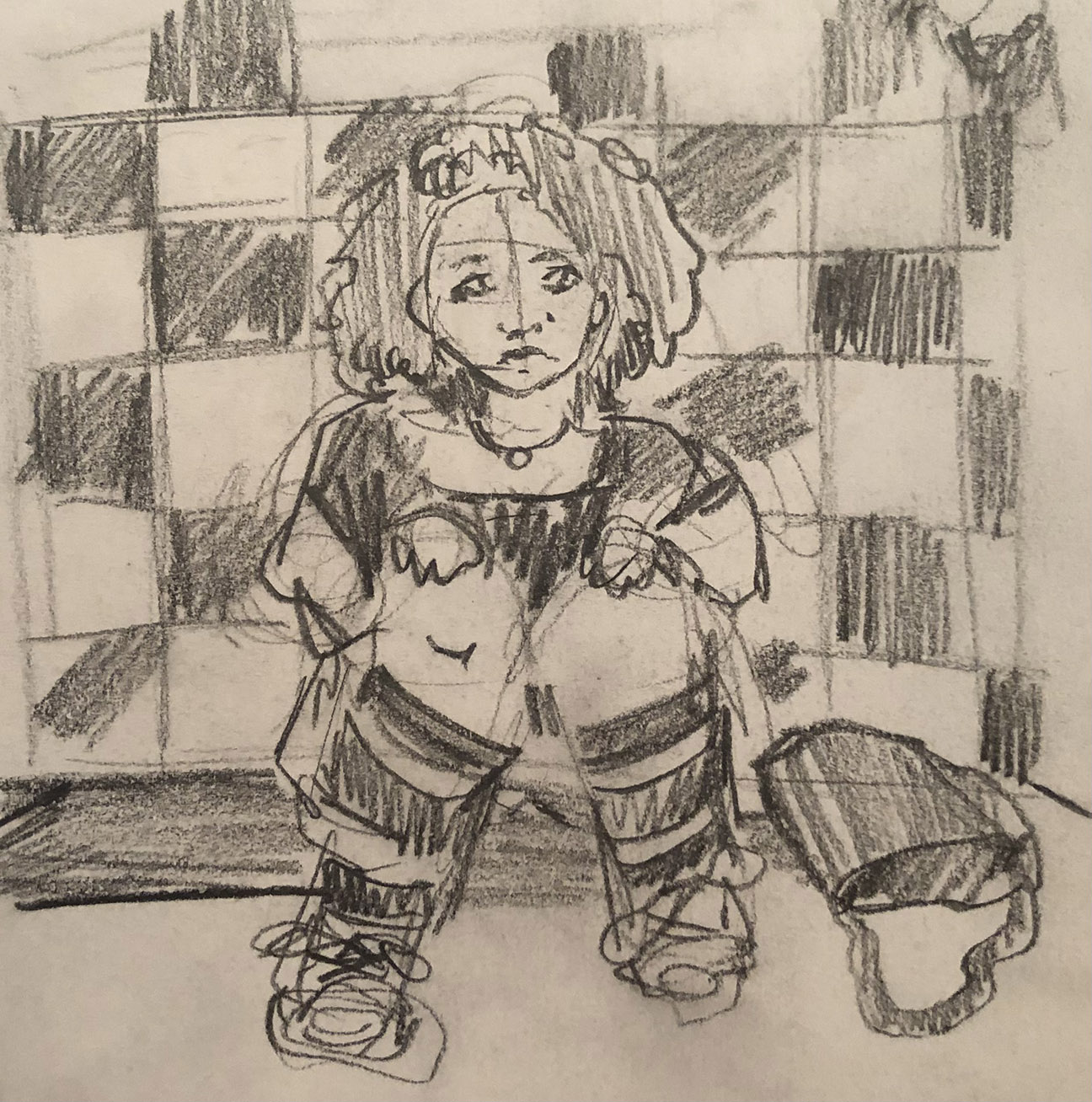 person kneeling in front of a checkered wall