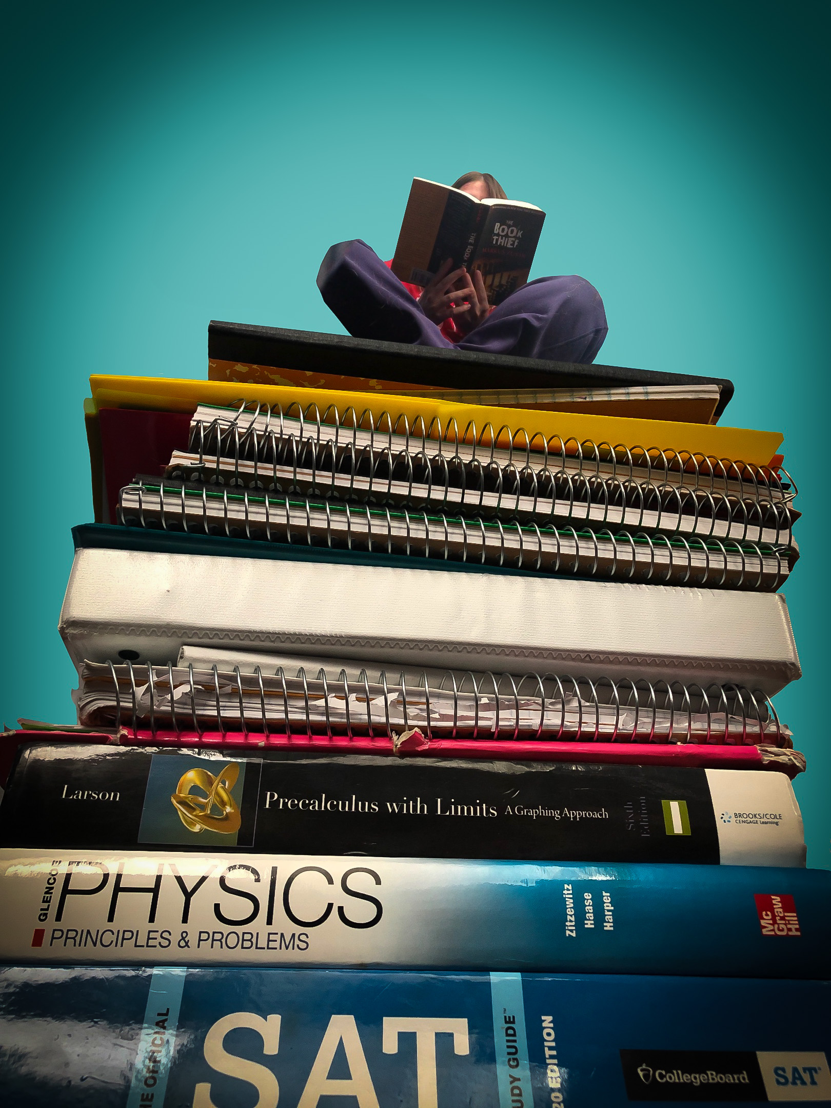 A student sitting atop a gigantic pile of textbooks and notebooks, reading a book that obscures their face