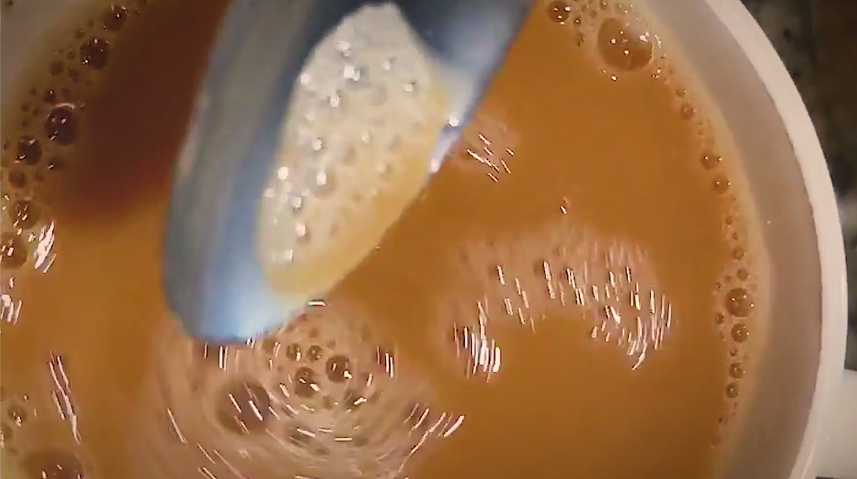 Spoon stirring cup of coffee