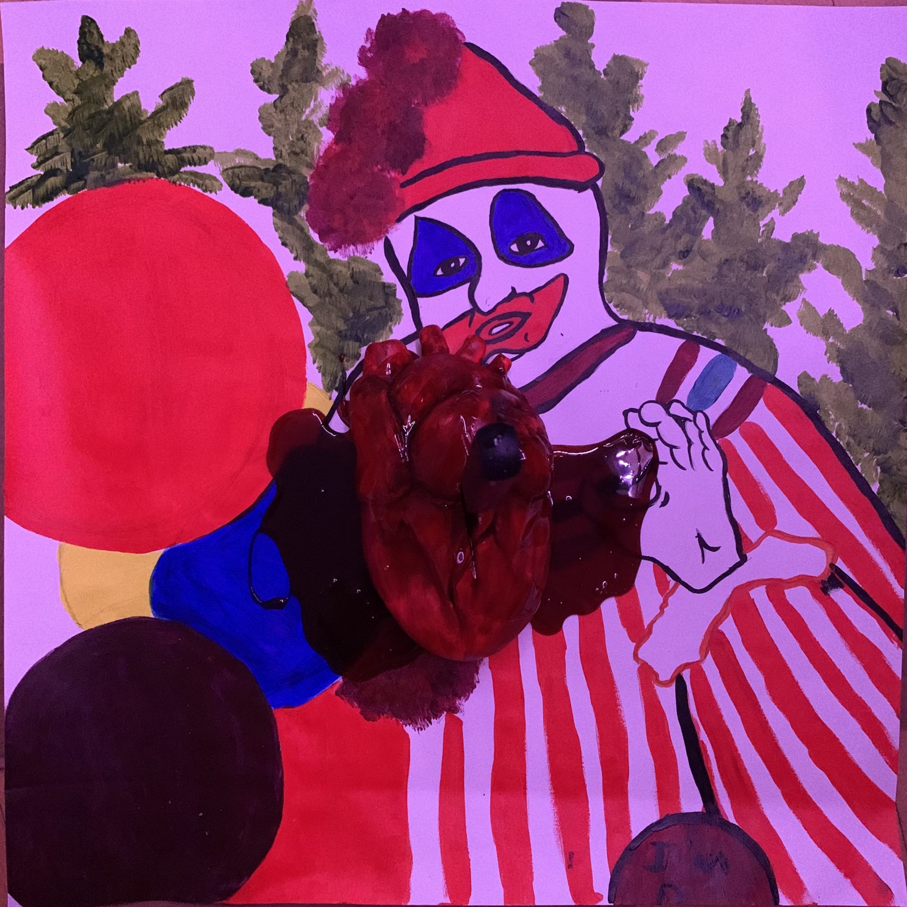 Acrylic painting of clown with blue-painted eyes and a red hat among trees. Atop the painting, a bleeding heart sits with fake blood pooling on the painting's surface