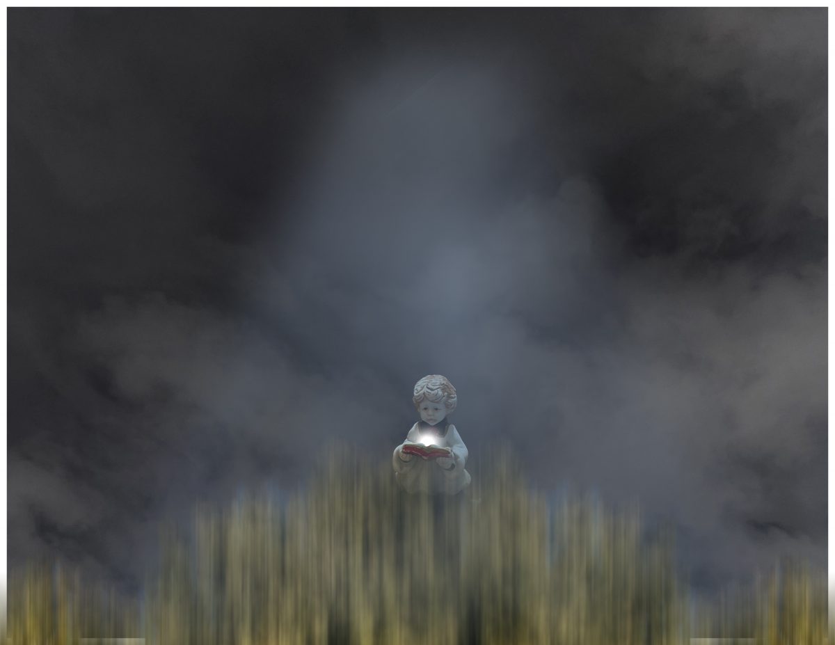 Photo of a stone cherub opening a stone book with a light glowing from the center of the book, in front of a backdrop of fog.