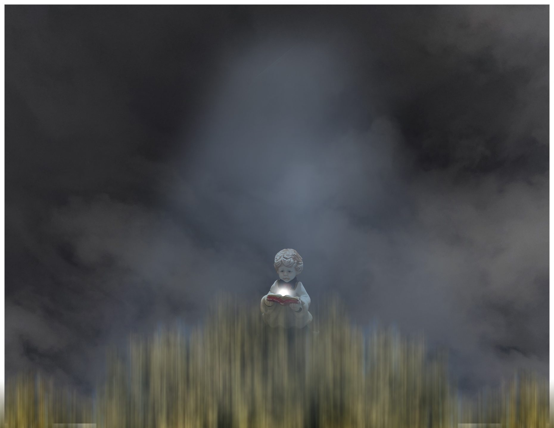 Photo of a stone cherub opening a stone book with a light glowing from the center of the book, in front of a backdrop of fog.