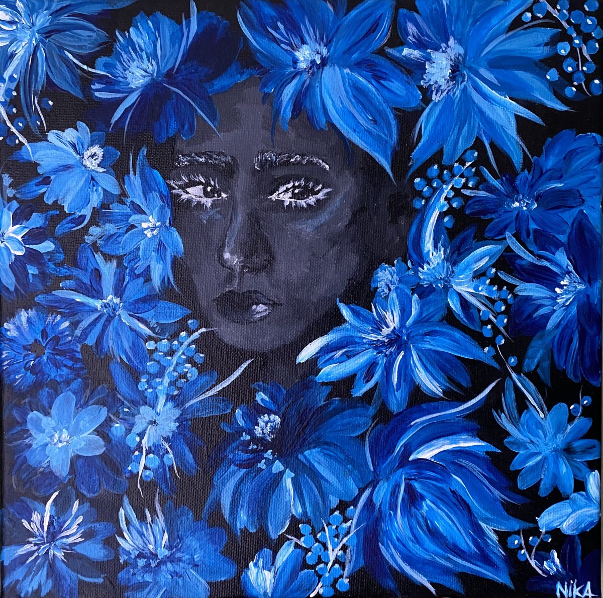Face in shadow, surrounded by blue flowers