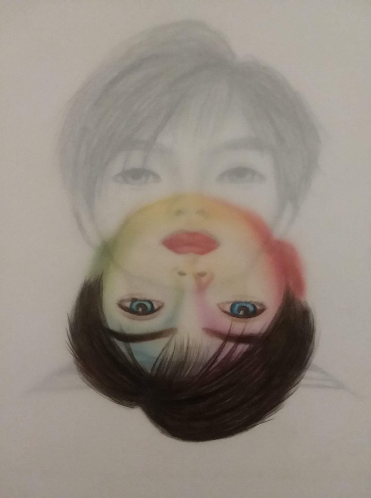 Black and white drawing of a face with dark hair and eyes. A color version of the face is reflected on the bottom half of the drawing.
