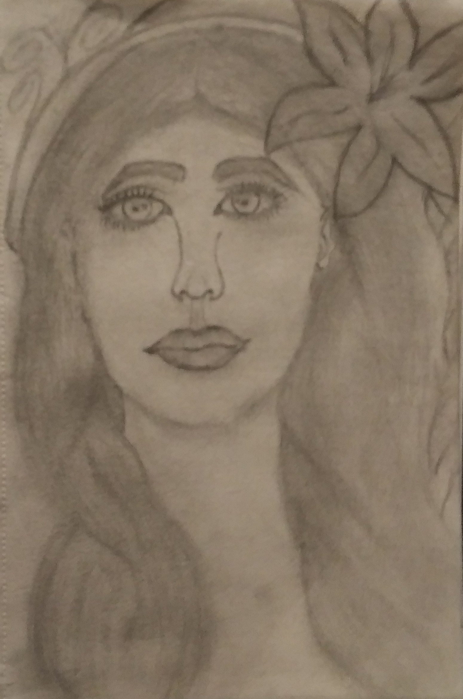 Black and white pencil drawing of a person's face with long hair and a flower in their hair.