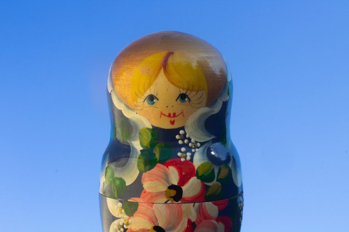 Photograph of a matryoshka (nesting) doll on a blue background