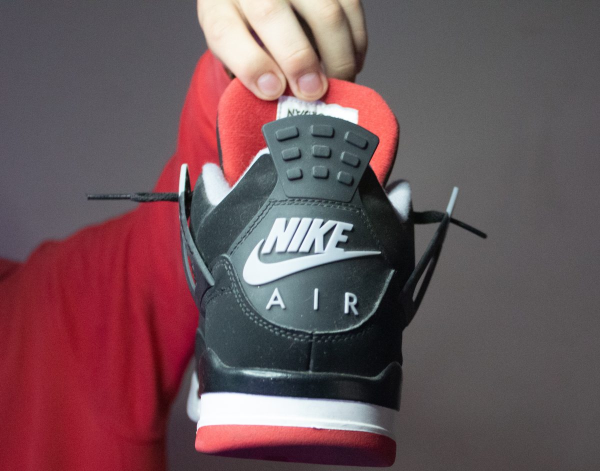 Picture of the heel of a black, white, and red Nike Air mid-top shoe.