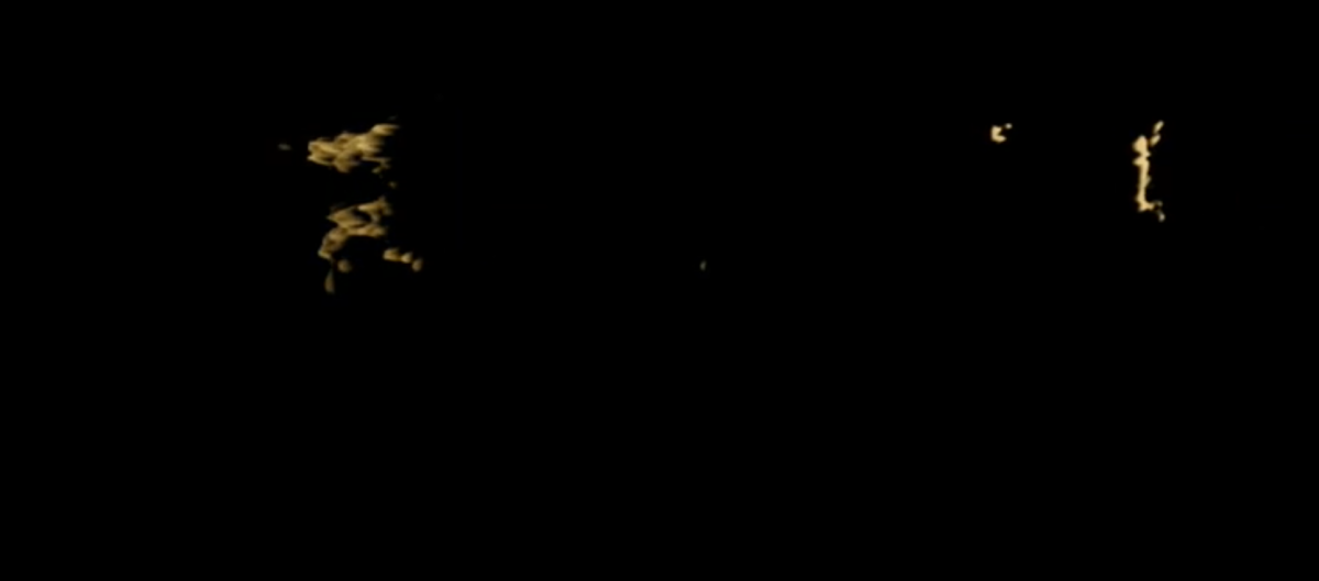 Black screen with barely visible yellow abstractions floating on top.