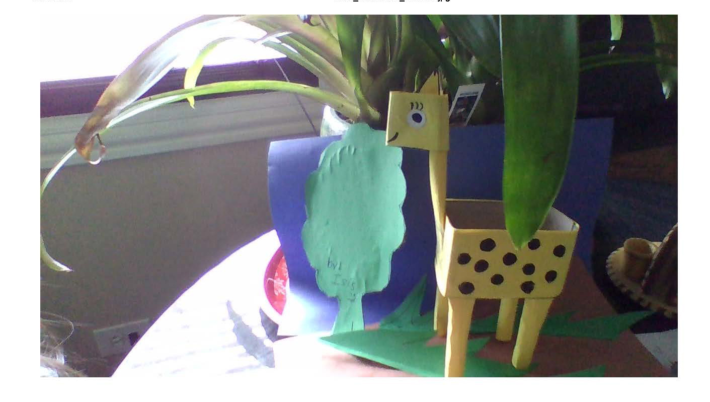 sculpture of a giraffe next to a plant