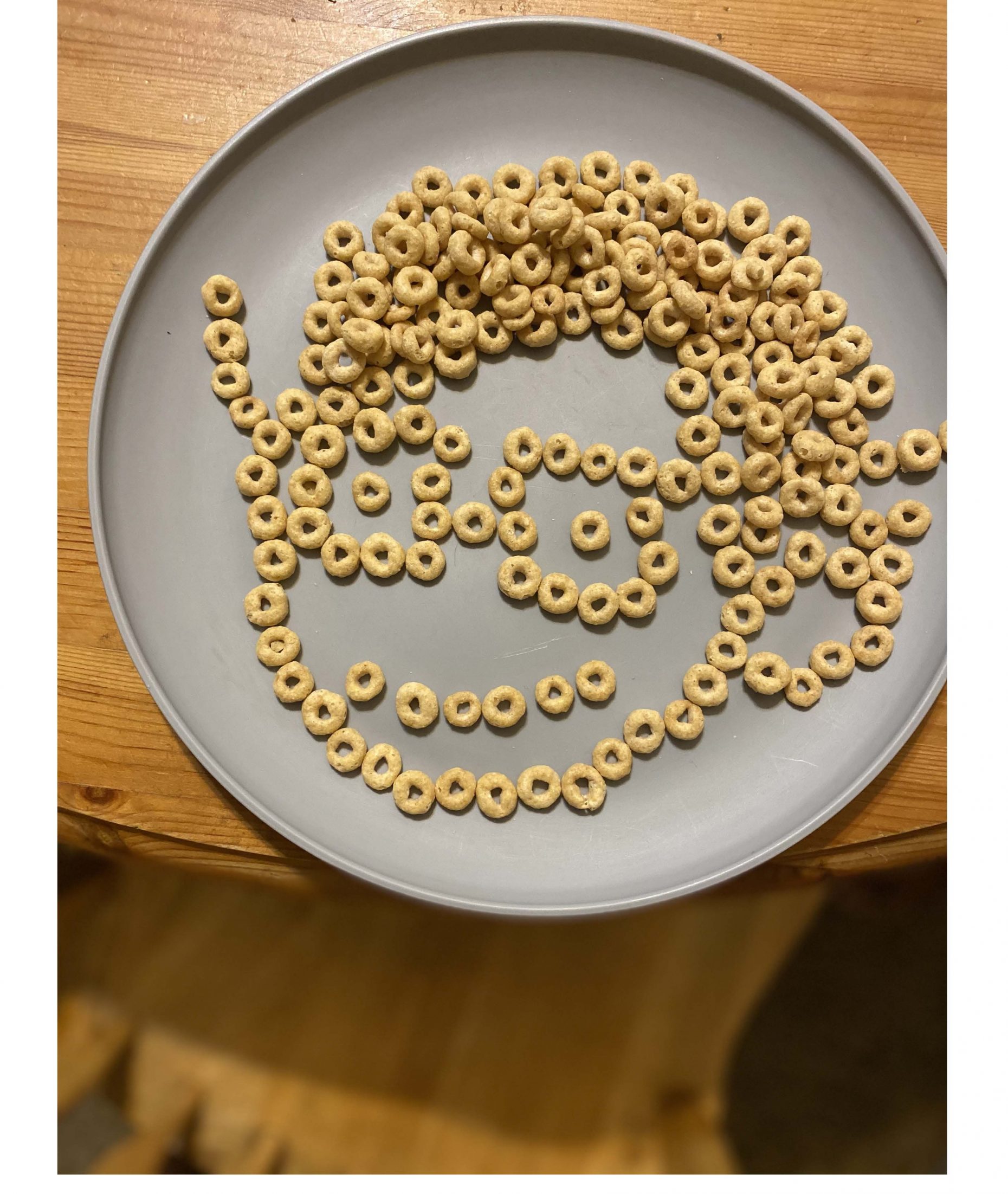 Cheerios on a plate in the shape of a face