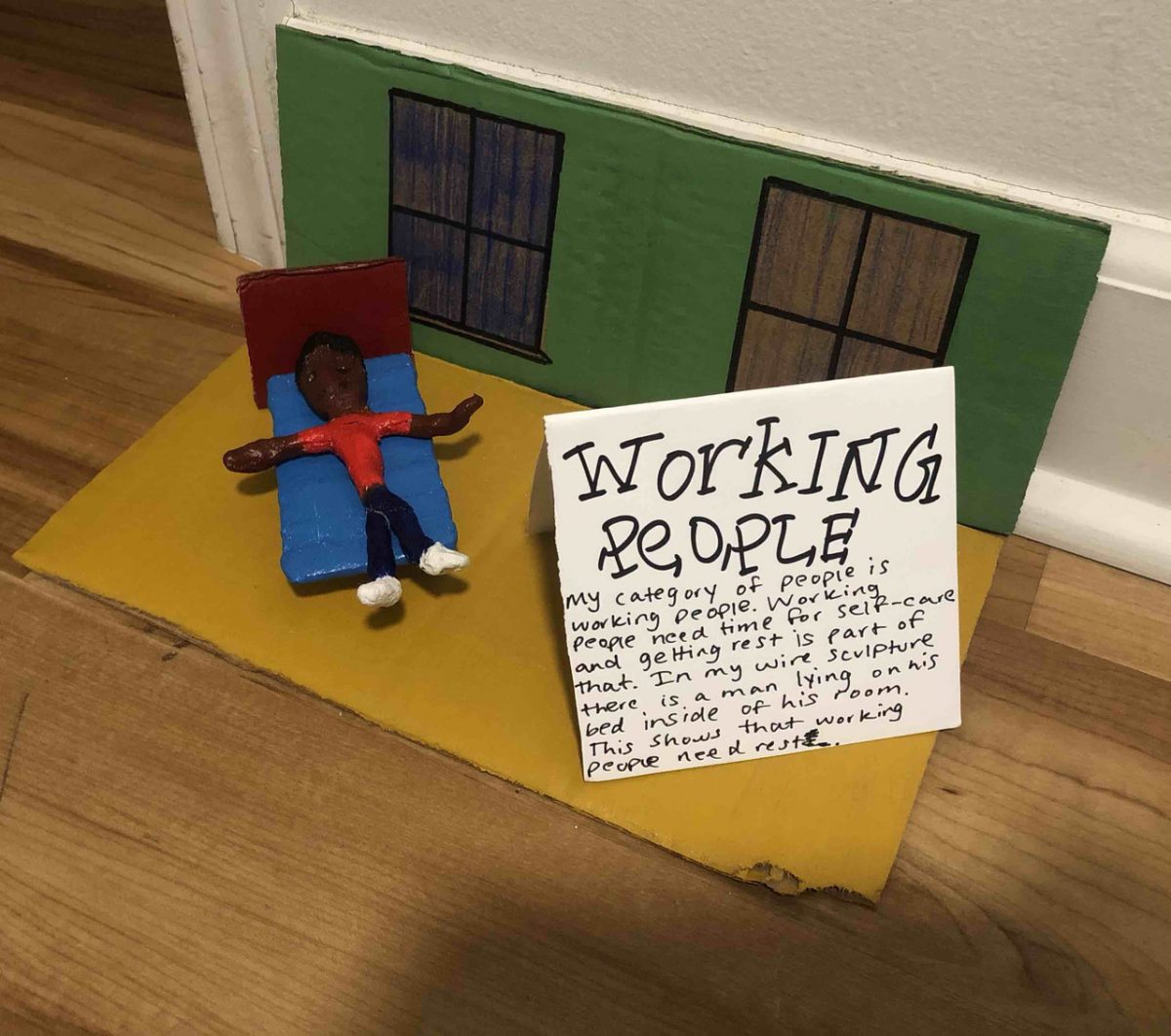 SCulpture of person with "working people" description