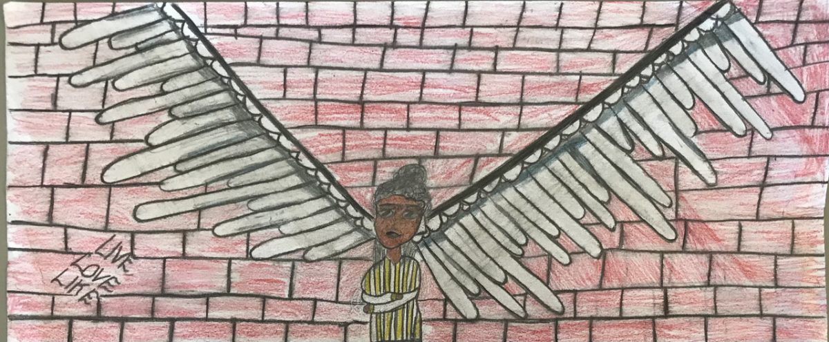 drawing of person in front of wings painted on brick wall