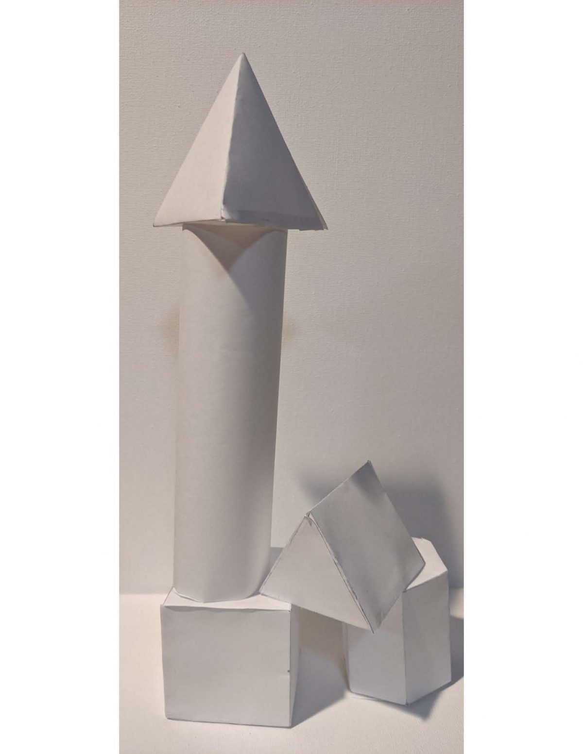 A paper sculpture of 3D white forms