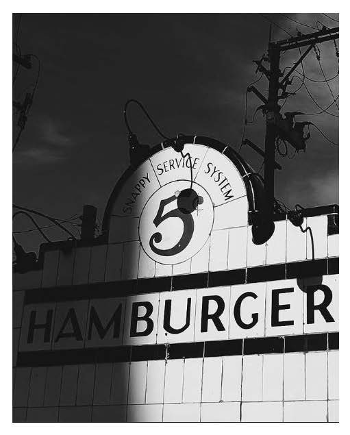 A black and white photo of a hamburger restaurant sign