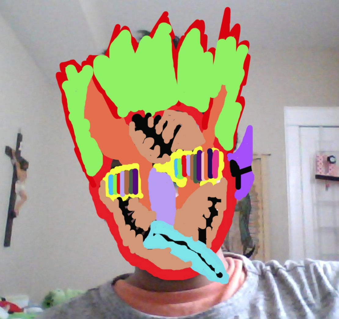 Photograph of a boy with a mask drawn on his face