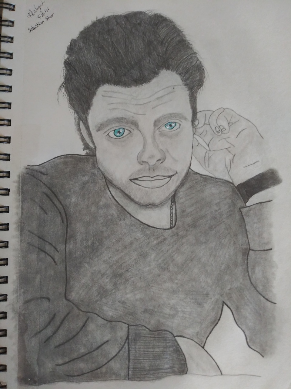 Pencil drawing of a person with dark hair wearing a watch. His eyes are bright blue.
