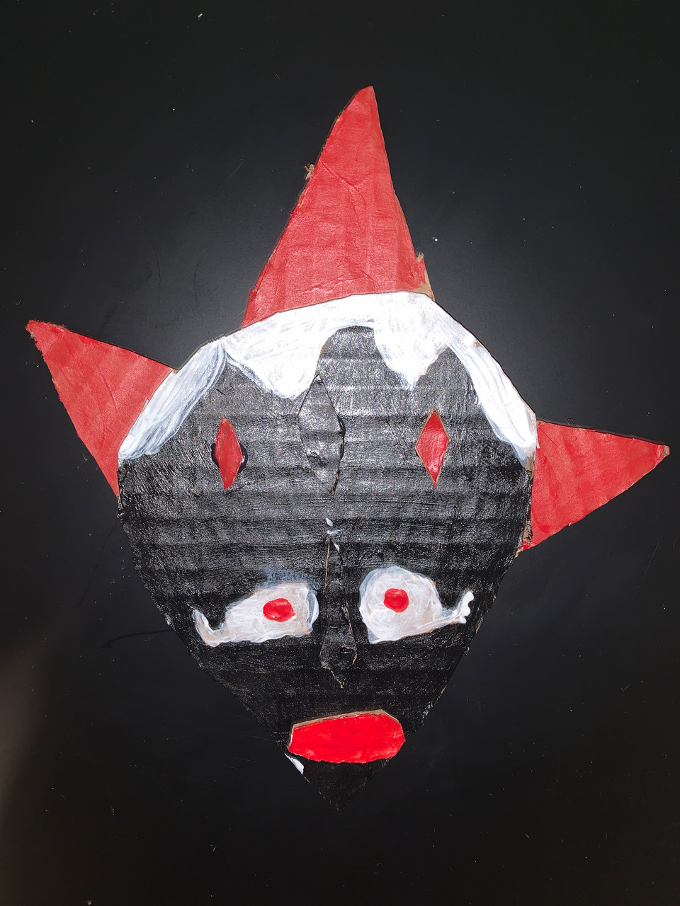 Black, red and white cardboard mask