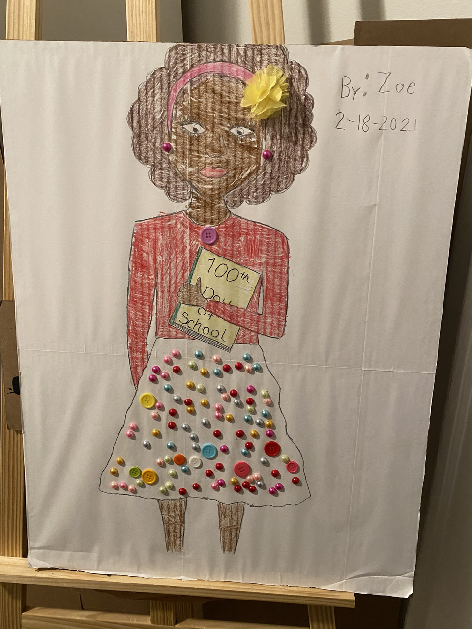 Drawing of a woman with buttons on her skirt and a red shirt