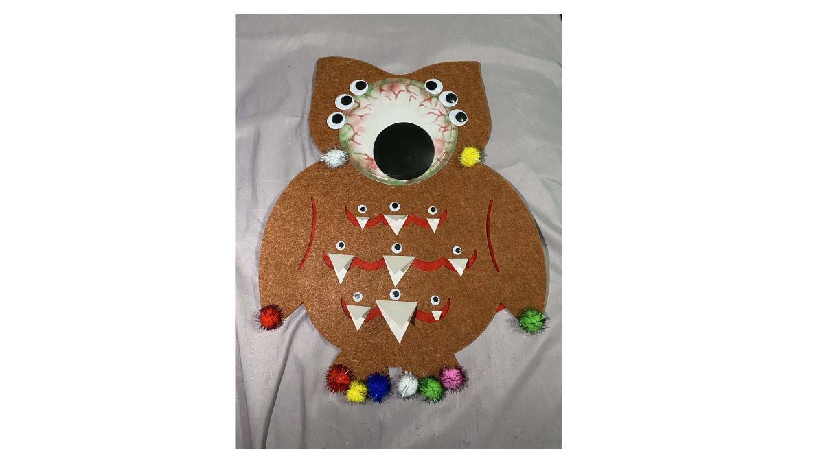 Owl puppet with googley eyes and fuzz balls
