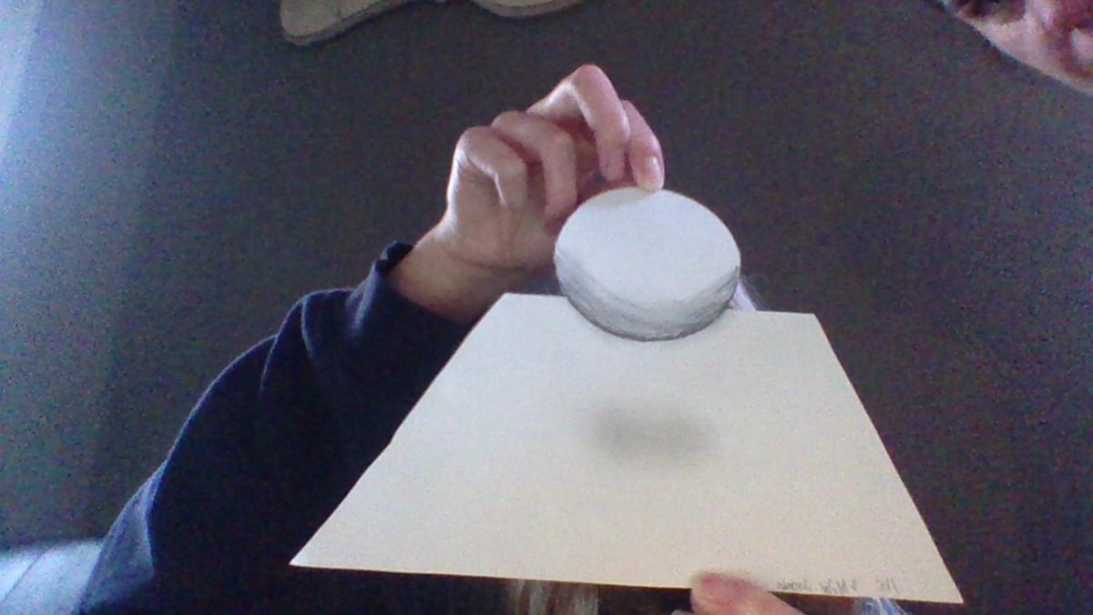 Person holding a sphere optical illusion drawing