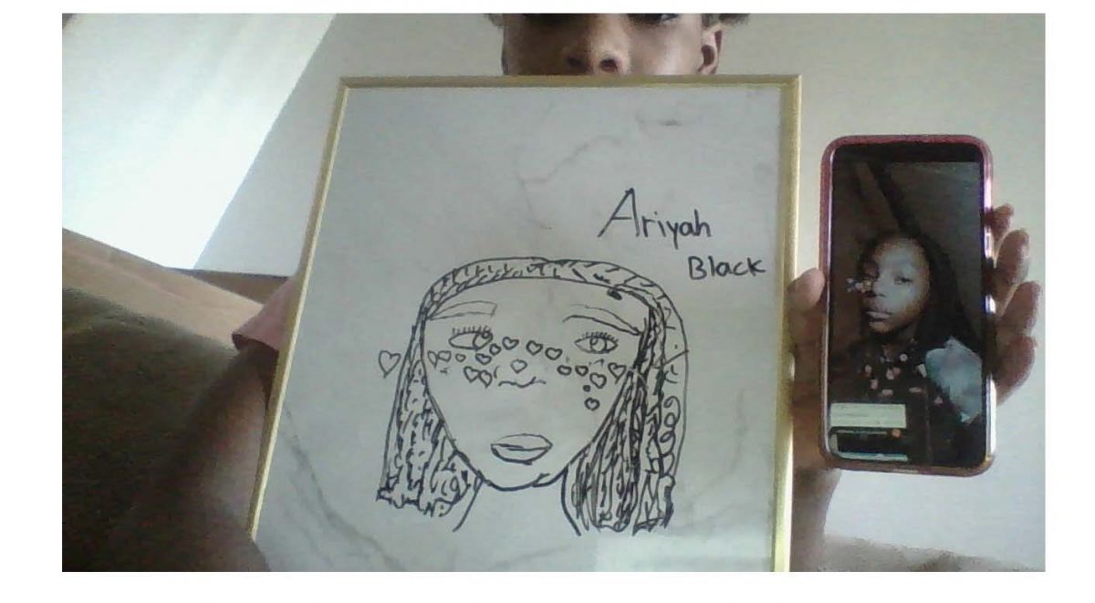 Photograph of person holding phone with picture and drawing of self.